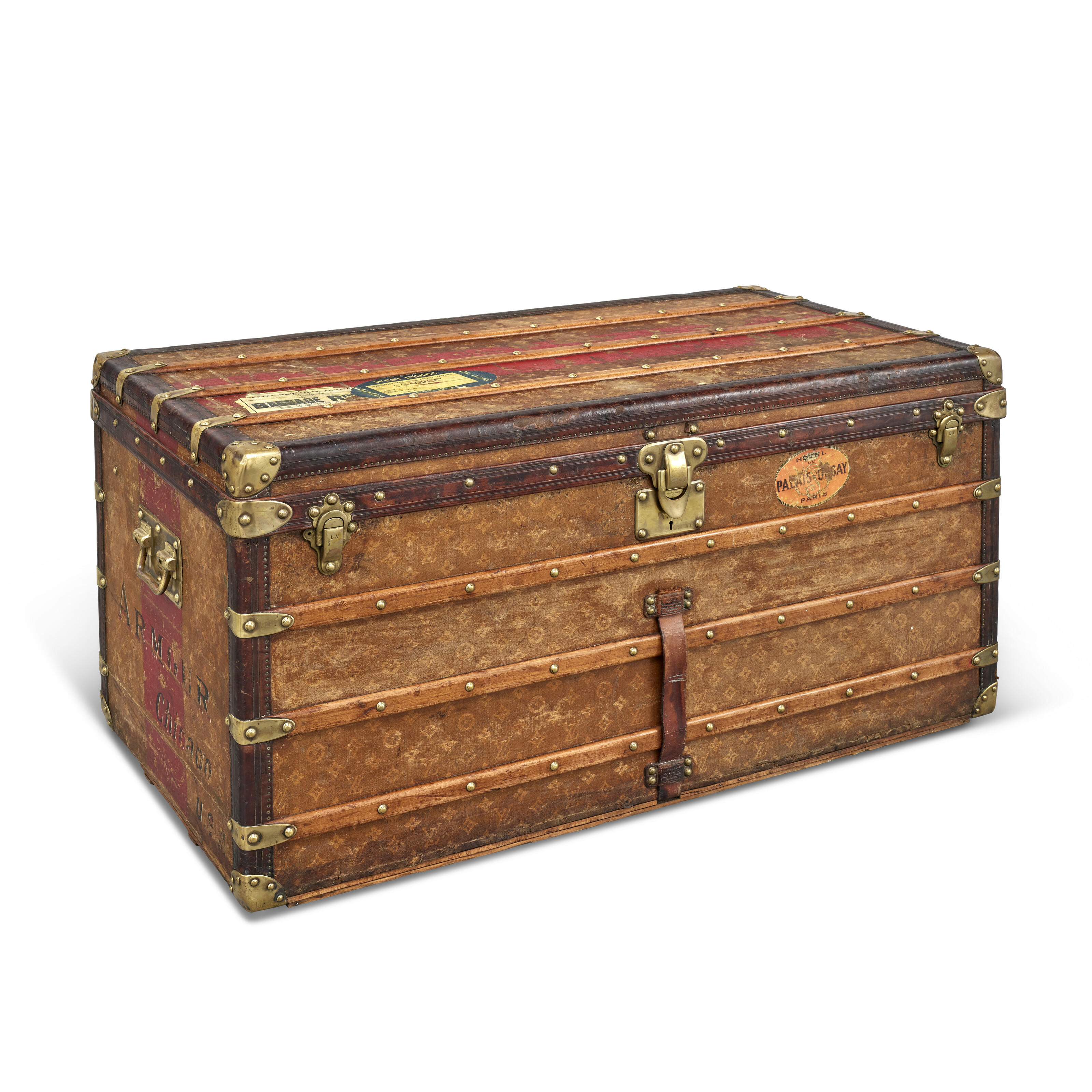AN ORANGE VUITTONITE CANVAS STEAMER TRUNK WITH BRASS HARDWARE