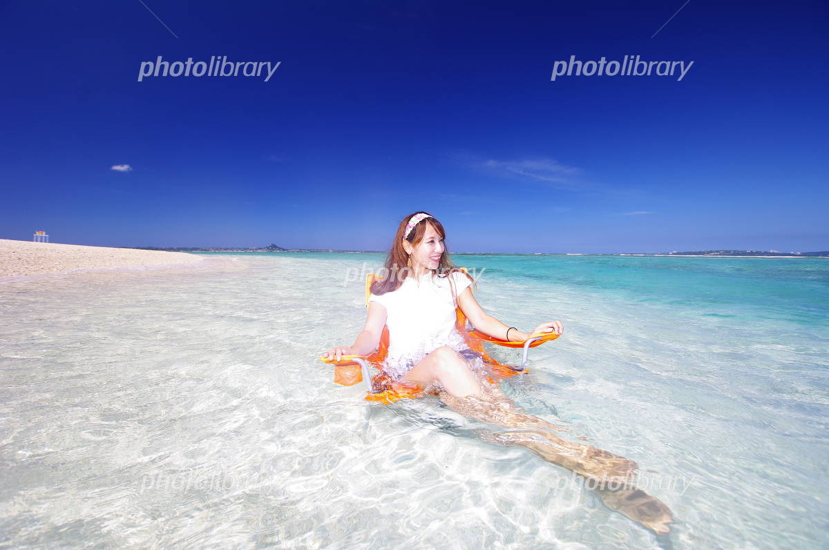 水納島の透明な海の中で水遊びをしている笑顔の女性 写真素材 [991007