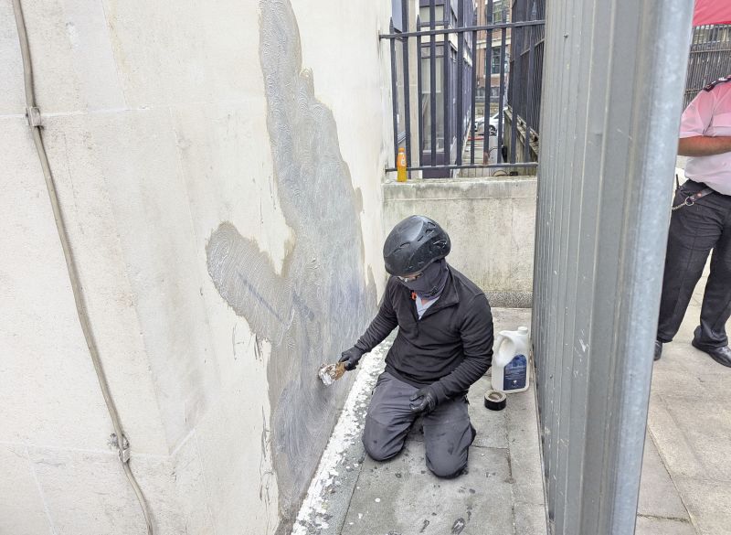 Banksy mural of judge beating protester is scrubbed from London