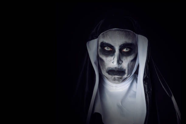 Frightening Evil Nun With A Lit Candle Stock Photo - Download