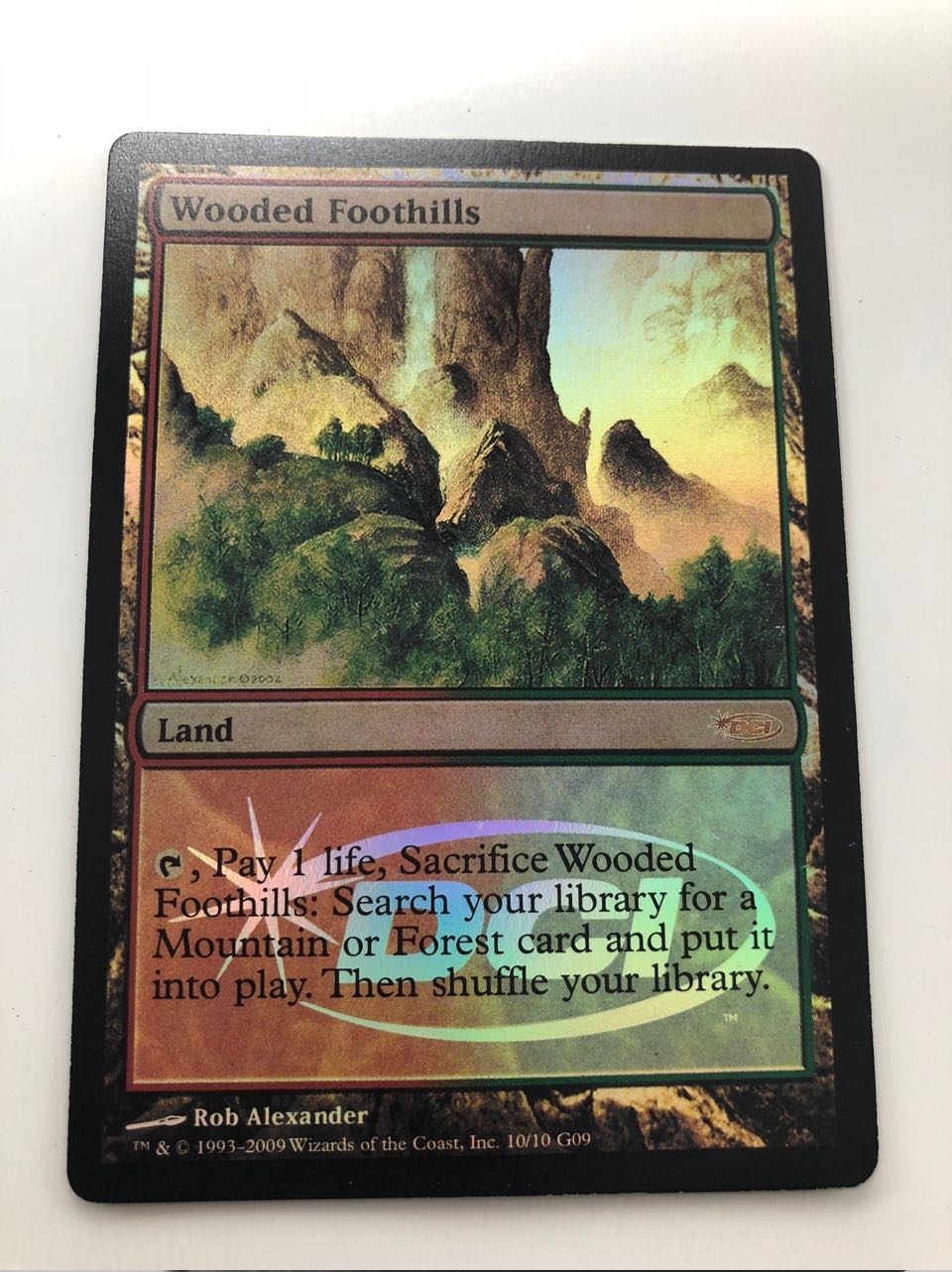 Foil Wooded Foothills DCI - MtgProxy