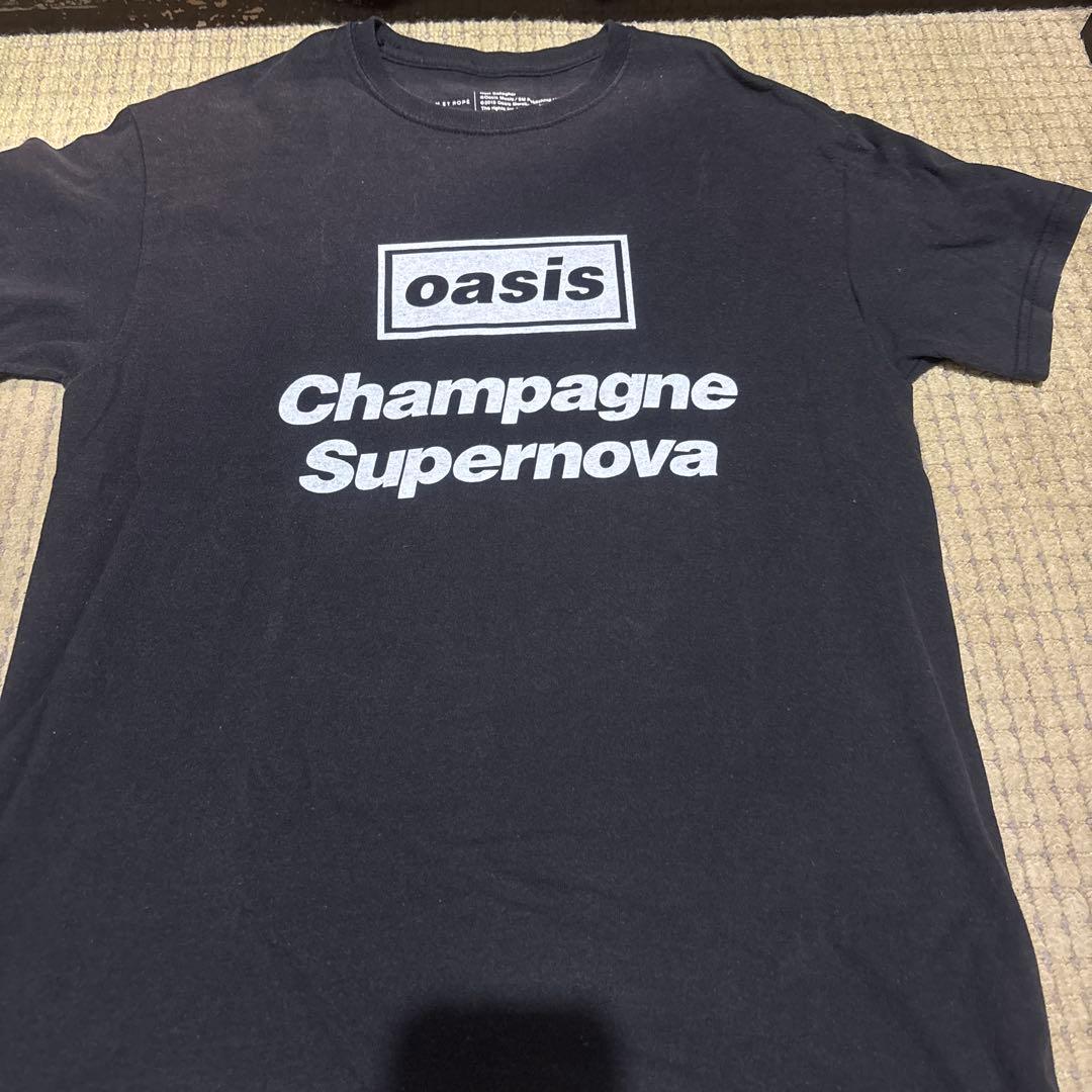 OASIS オアシスTシャツ オフィシャルChampagne OASIS オアシス (結成 35周年 ) - Definitely Maybe Text Logo / T