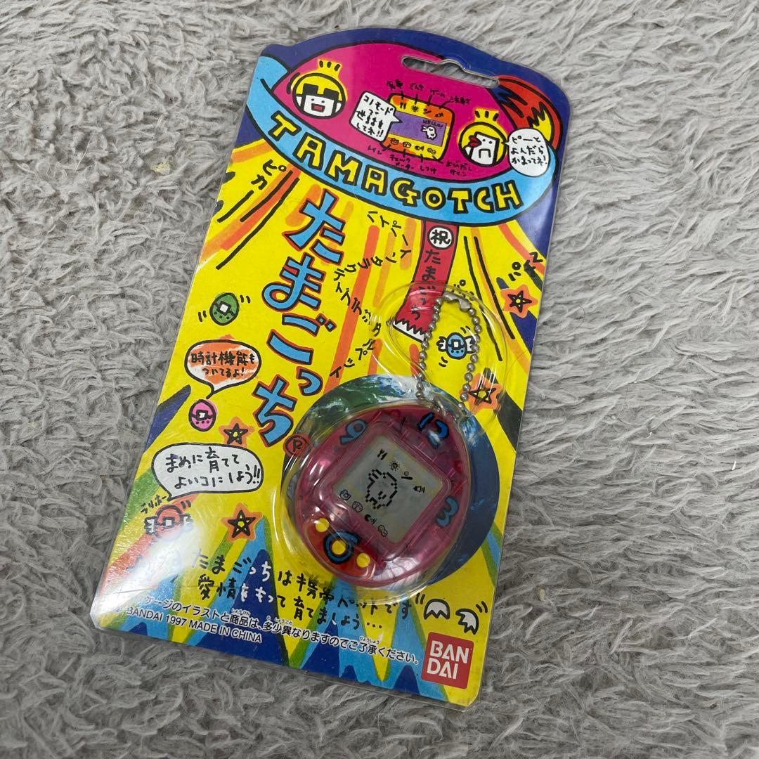 初代　たまごっち　1997年製 スケルトンピンク 動作確認済み】たまごっち 初代 スケルトンピンク 時計柄 バンダイ