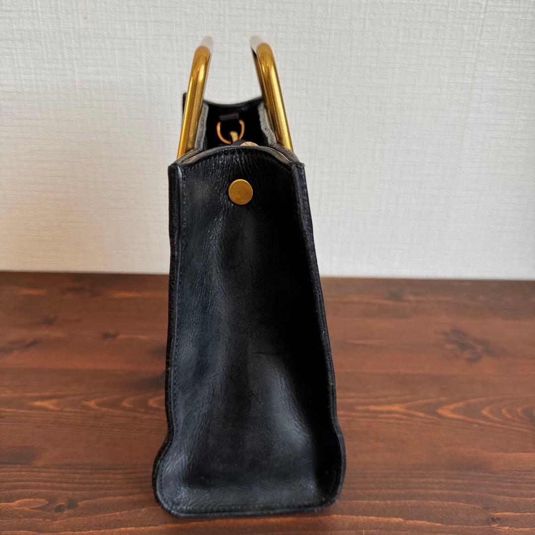 Emma Aura ゴールドハンドルバッグ 黒 - メルカリ