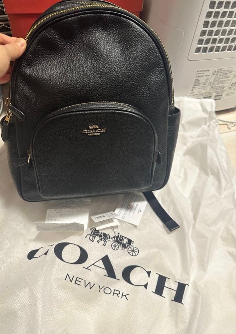バッグ COACH PEBBLED LEATHER COURT BACKPACK